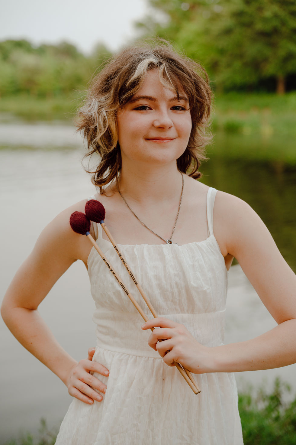 Senior Girl with percussion sticks musical instrument during her senior portrait session Keller Pointe, Keller, Texas
