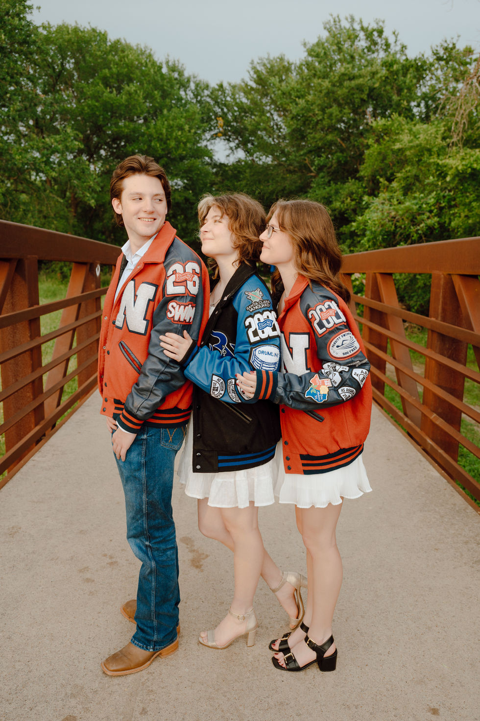 Seniors on bridge in letter jackets at Keller Pointe Dallas Fort Worth, Texas