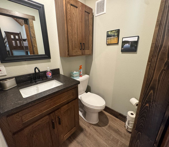 a half bathroom with toilet and vanity