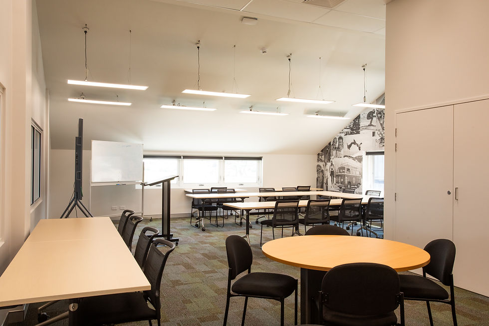 Modern classroom with tables, chairs, and whiteboard in NSTC HP Centre