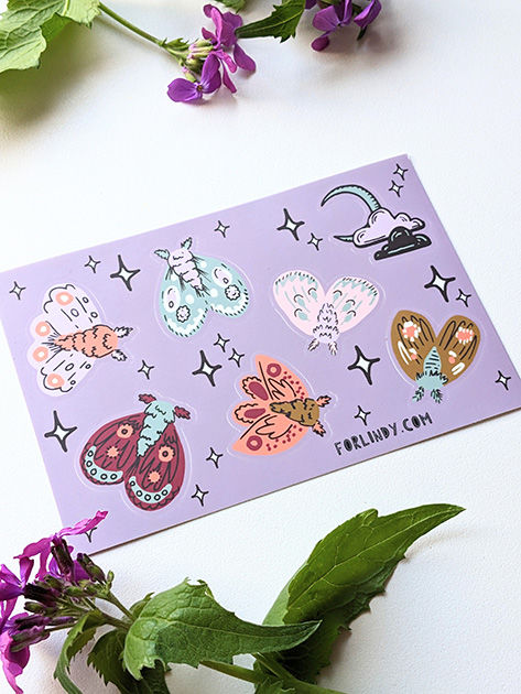 Sticker sheet with six moths and one moon with two clouds