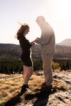 Couple holding hands with mountain backdrop. Engagement Photography Chase and Tyler.