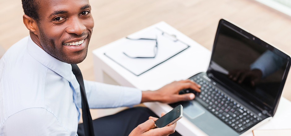Smiling Man on Laptop