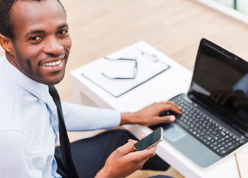 Smiling Man on Laptop