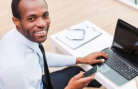 Smiling Man on Laptop