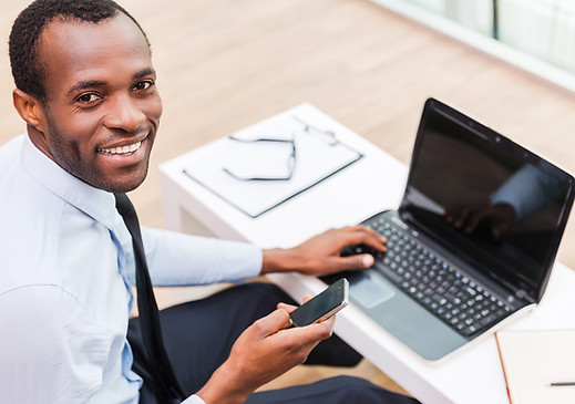 Smiling Man on Laptop