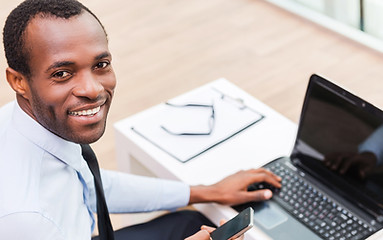 Smiling Man on Laptop