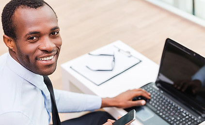 Smiling Man on Laptop
