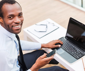 Smiling Man on Laptop