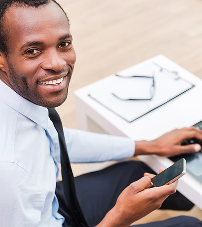 Smiling Man on Laptop