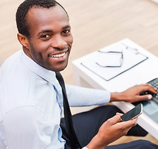 Smiling Man on Laptop