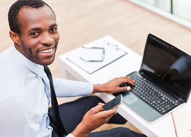 Smiling Man on Laptop