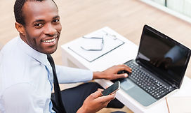 Smiling Man on Laptop