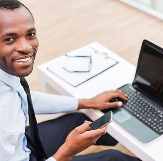 Smiling Man on Laptop