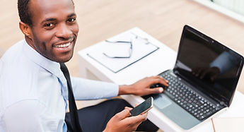 Smiling Man on Laptop