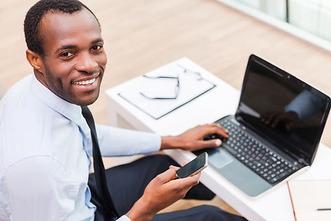 Smiling Man on Laptop