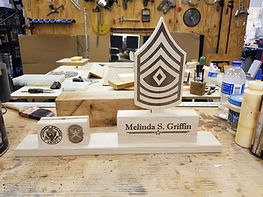 Handcrafted military retirement plaques and custom engraved awards displayed at WIC Gifts Custom Shop.