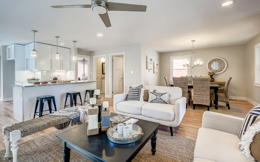LIVING ROOM WITH WHITE FURNITURE AND WOOD FLOORS
