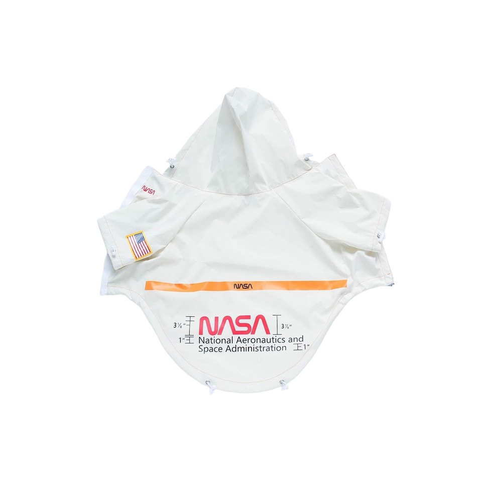 White dog raincoat with NASA patch and adjustable hood.