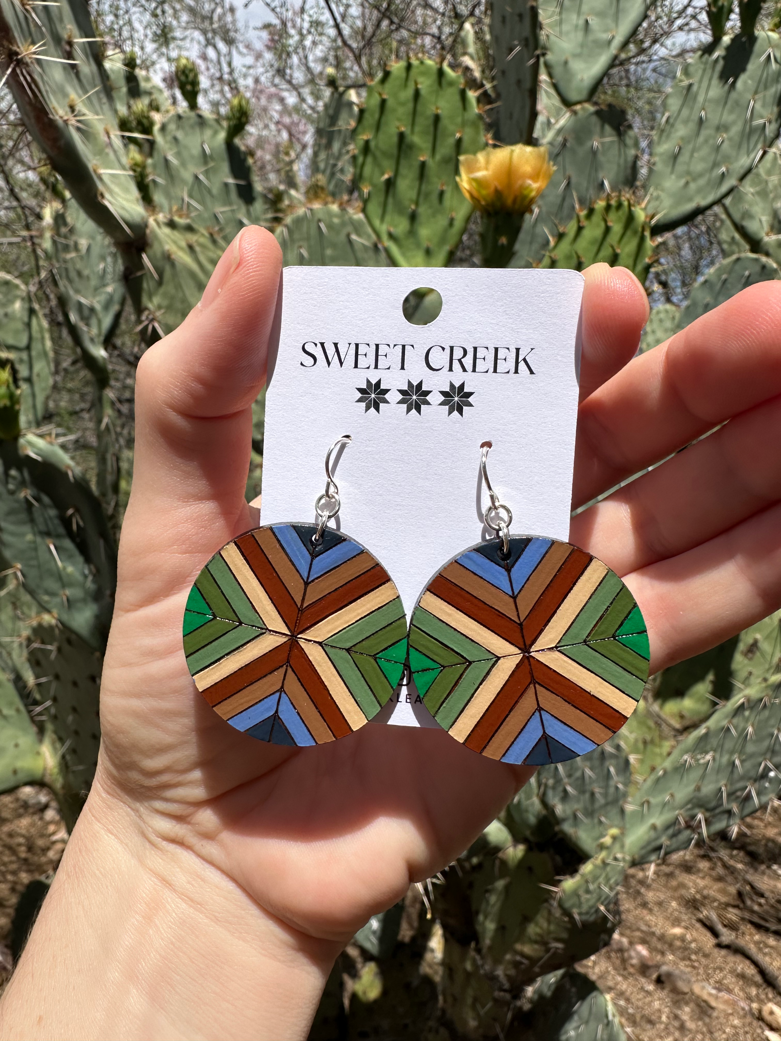 Earth tone geometric leather earrings in round design with green, tan, blue, and brown shades, handmade jewelry desert