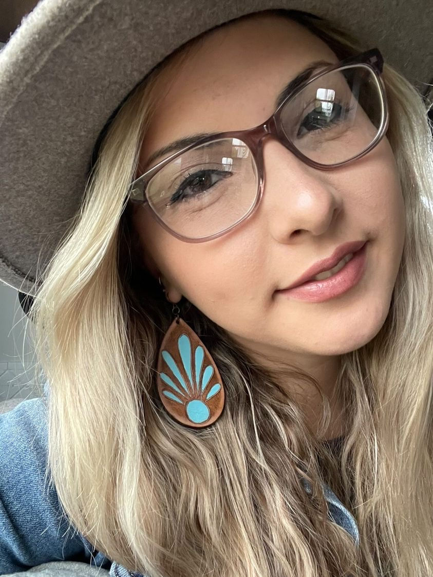 Model wearing our handcrafted hand-painted leather shell earrings in Indian Turquoise