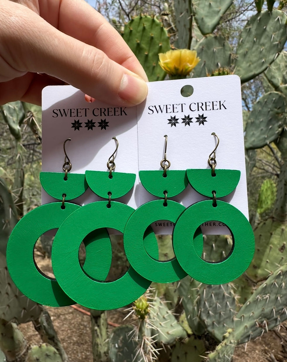 Bright green leather hoop earrings in minimalist geometric design, handmade lightweight earrings with desert backdrop