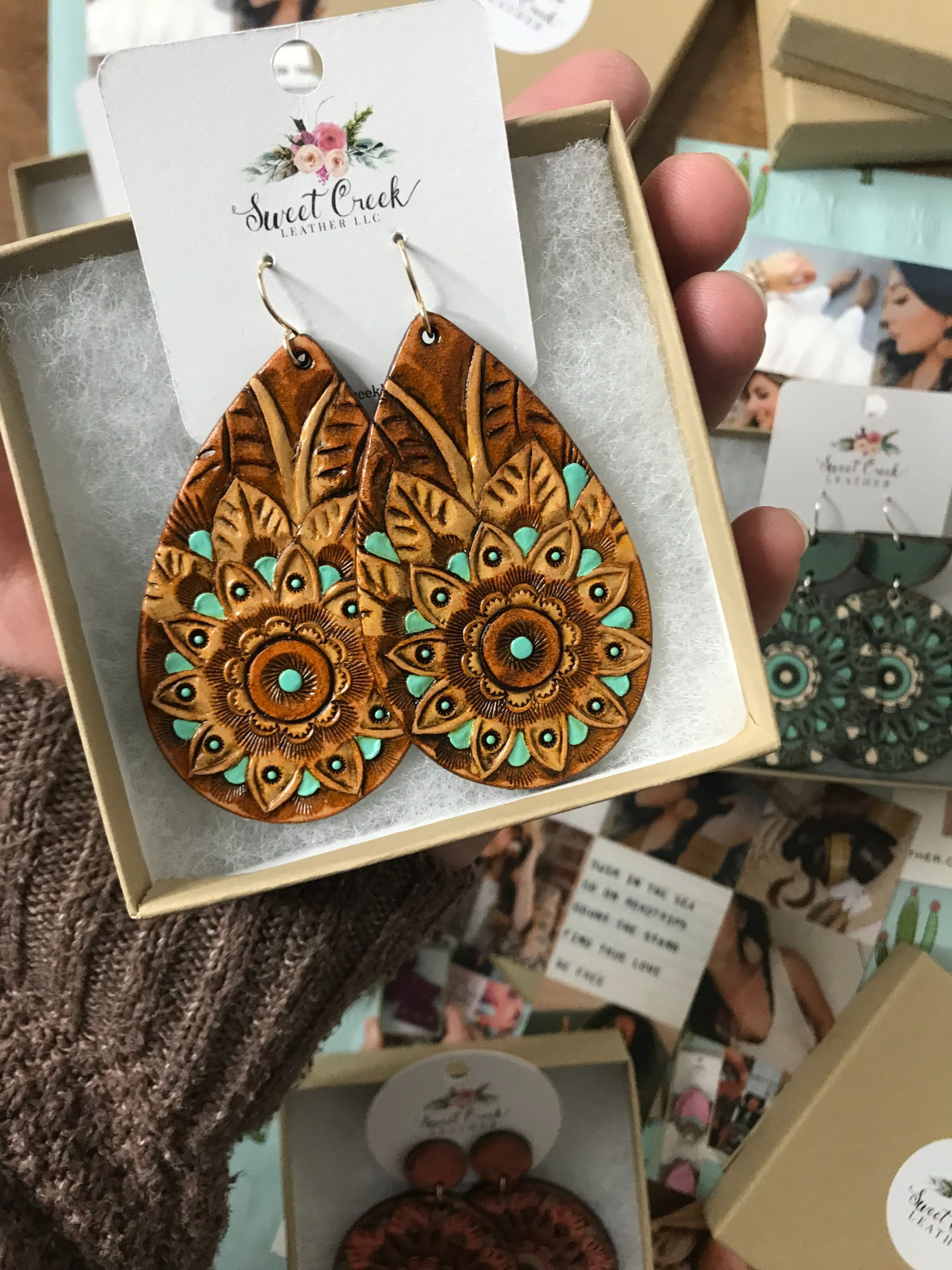 OOAK Handcrafted artisan leather earrings. Fine leather jewelry. Unique hand drawn and tooled geometric leather flower design. Hand painted turquoise, tan, brown. Unique. Original designs. Teardrop shape.