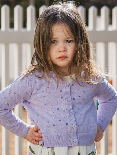 Preschool student outside by a fence in New Hampshire