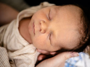 Sleeping newborn during lifestyle newborn photography session in Lebanon, NH