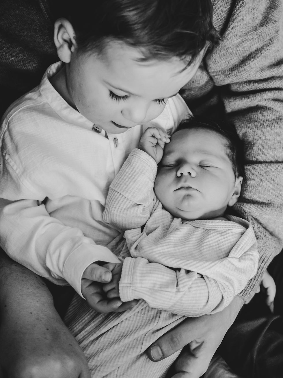 When Should Newborn Photos Be Taken - toddler holding newborn