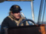 Skip at the helm of his boat, Aida