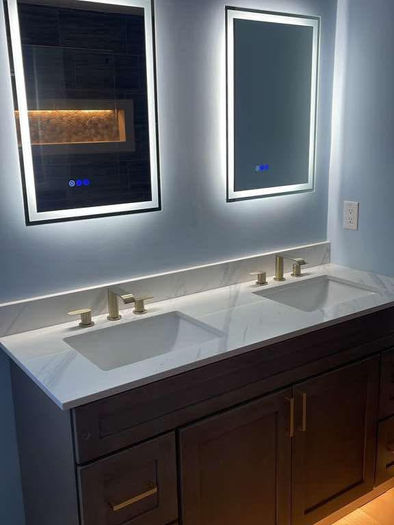 Custom double vanity with LED mirrors and quartz countertop in a modern bathroom remodel in Collegeville, PA