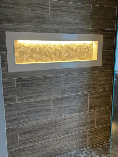 luxury frameless glass shower with pebble flooring in collegeville PA