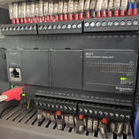 Electrical cabinet with Schneider Electric programmable logic controller (PLC).