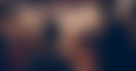 The bride and groom smile as they raise sparklers above their heads, creating a magical atmosphere for their celebration.