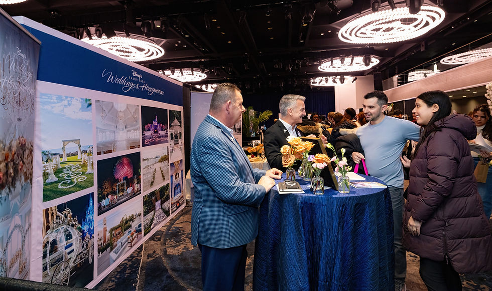 Wedding venue vendor talking to engaged couples at a wedding show.