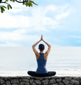Woman meditating by the sea