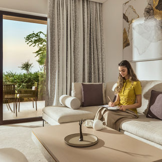 Woman relaxing in luxurious villa, writing in notebook