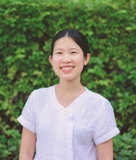 Smiling woman, white shirt, green background