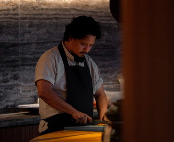 Chef meticulously slicing ingredients