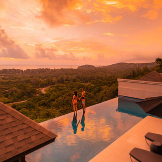 Couple enjoying sunset view from infinity pool