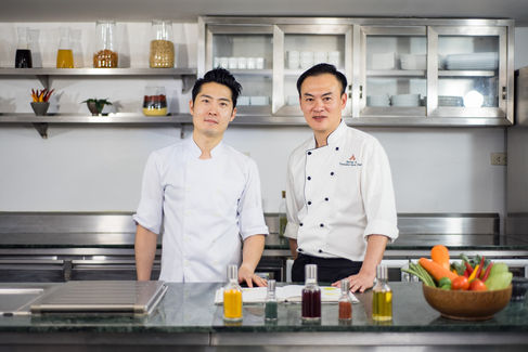 Two chefs in a kitchen, showcasing culinary expertise