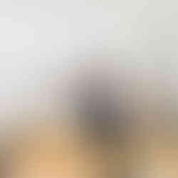 Pilates instructor assisting client with leg extension exercise