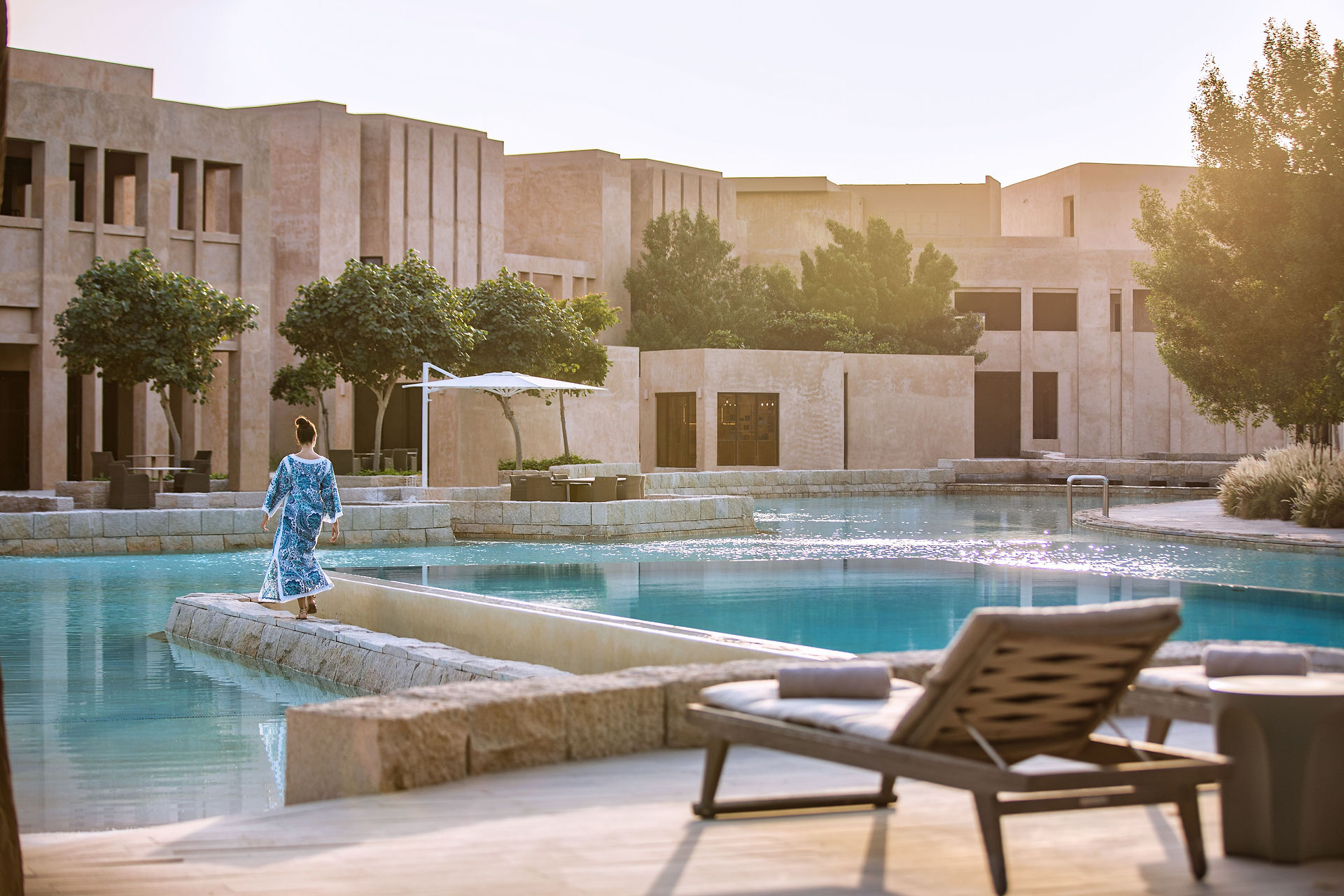 Person walking by resort pool