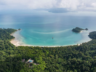Aerial view of tranquil beach, lush green landscape