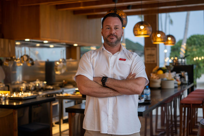 Portrait of a man with arms crossed in a modern kitchen