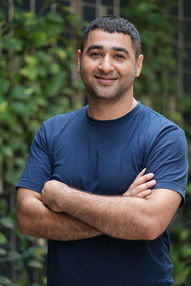 Smiling man with arms crossed