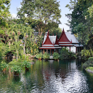Serene red-roofed spa nestled on tranquil pond