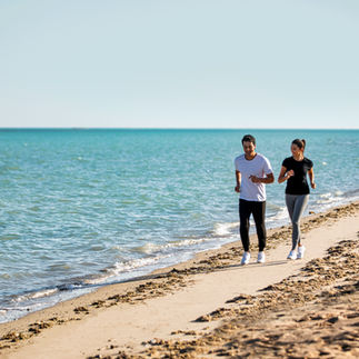 Couple jogging on a sandy beach