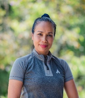 Portrait of a woman wearing a gray collared shirt